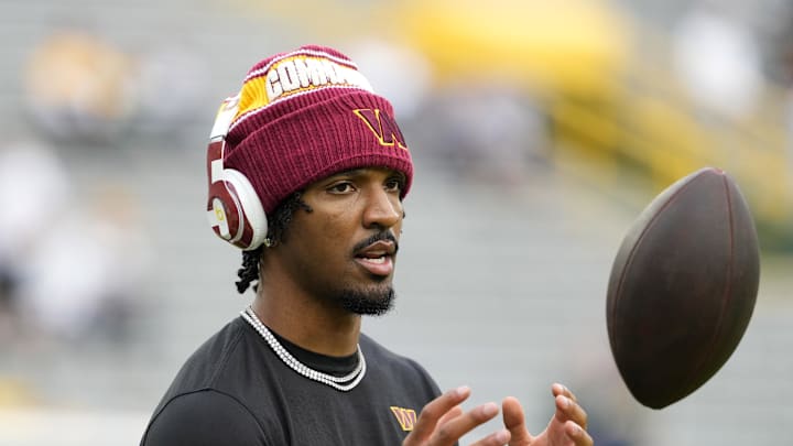Sep 11, 2025; Green Bay, Wisconsin, USA; Washington Commanders quarterback Jayden Daniels (5) warms up before a game against the Green Bay Packers at Lambeau Field. Mandatory Credit: Jeff Hanisch-Imagn Images