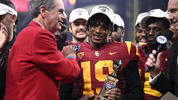 Dec 27, 2023; San Diego, CA, USA; USC Trojans safety Jaylin Smith (19) is presented the defensive MVP trophy after defeating the Louisville Cardinals at Petco Park. Mandatory Credit: Orlando Ramirez-Imagn Images Dec 27, 2023; San Diego, CA, USA; USC Trojans safety Jaylin Smith (19) is presented the defensive MVP trophy after defeating the Louisville Cardinals at Petco Park. Mandatory Credit: Orlando Ramirez-Imagn Images