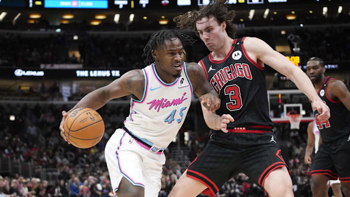 Apr 9, 2025; Chicago, Illinois, USA; Chicago Bulls guard Josh Giddey (3) defends Miami Heat guard Davion Mitchell (45) during the second half at United Center. Mandatory Credit: David Banks-Imagn Images