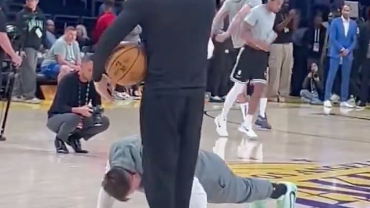 Doncic doing push-ups on the court. 
