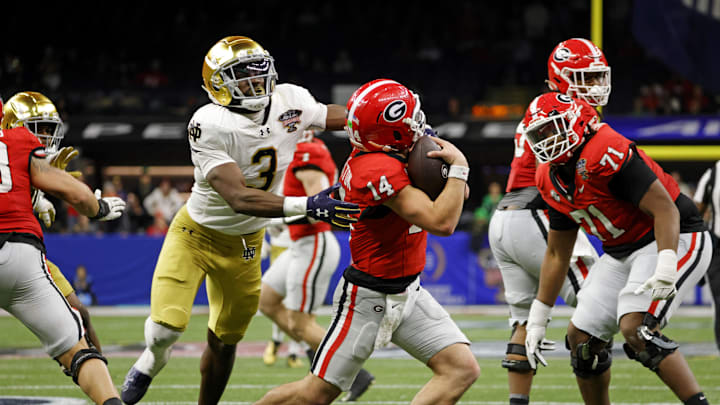 Jan 2, 2025; New Orleans, LA, USA; Georgia Bulldogs quarterback Gunner Stockton (14) runs with the ball during the second half against Notre Dame Fighting Irish running back Gi'Bran Payne (3) at Caesars Superdome. Mandatory Credit: Amber Searls-Imagn Images