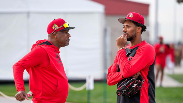 Cincinnati Reds pitcher Hunter Greene (21) talks with special assistant to the general manager, Eric Davis, at the Cincinnati Reds player development complex in Goodyear, Ariz., on Wednesday, Feb. 11, 2026.