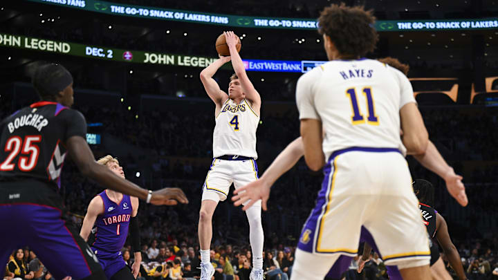 Nov 10, 2024; Los Angeles, California, USA; Los Angeles Lakers guard Dalton Knecht (4) shoots against Toronto Raptors guard Gradey Dick (1) and forward Chris Boucher (25) during the first half at Crypto.com Arena. Mandatory Credit: Jonathan Hui-Imagn Images Nov 10, 2024; Los Angeles, California, USA; Los Angeles Lakers guard Dalton Knecht (4) shoots against Toronto Raptors guard Gradey Dick (1) and forward Chris Boucher (25) during the first half at Crypto.com Arena. Mandatory Credit: Jonathan Hui-Imagn Images