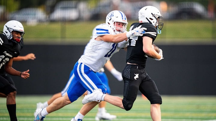 Waukee Northwest's Brady Fitz (11) reaches out for a tackle on Roosevelt's Jake Boeding (24) on Thursday, Sept. 12, 2024, at Mediacom Stadium in Des Moines. Waukee Northwest's Brady Fitz (11) reaches out for a tackle on Roosevelt's Jake Boeding (24) on Thursday, Sept. 12, 2024, at Mediacom Stadium in Des Moines.