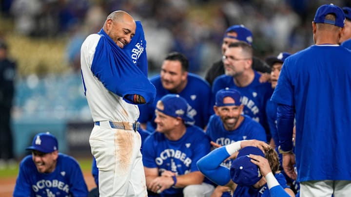 Los Angeles Dodgers shortstop Mookie Betts (50) joins his teammates in celebration after the ninth inning of the MLB National League Wild Card Game 2 between the Los Angeles Dodgers and the Cincinnati Reds at Dodger Stadium in Los Angeles on Wednesday, Oct. 1, 2025. The Reds were eliminated from the postseason with an 8-4 loss to the reining World Series Champions La Dodgers.