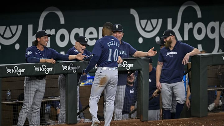 Seattle Mariners right fielder Victor Robles (10) celebrates with his teammates after he scores against the Texas Rangers during the sixth inning at Globe Life Field in 2024. Seattle Mariners right fielder Victor Robles (10) celebrates with his teammates after he scores against the Texas Rangers during the sixth inning at Globe Life Field in 2024.