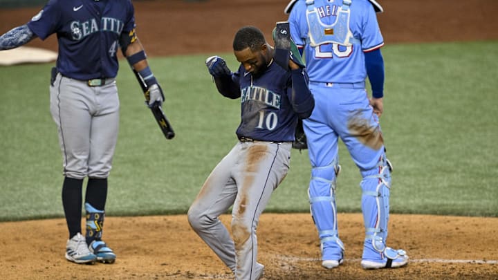 Seattle Mariners right fielder Victor Robles (10) celebrates at home plate after he scores against the Texas Rangers during the sixth inning at Globe Life Field in 2024. Seattle Mariners right fielder Victor Robles (10) celebrates at home plate after he scores against the Texas Rangers during the sixth inning at Globe Life Field in 2024.