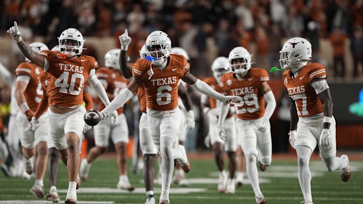 Texas Longhorns defensive back Kobe Black (6) and teammates react after making an interception during the second half against the Texas A&M Aggies at Darrell K Royal-Texas Memorial Stadium.