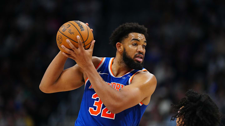 Nov 25, 2024; Denver, Colorado, USA; New York Knicks center Karl-Anthony Towns (32) controls the ball over Denver Nuggets guard Julian Strawther (3) in the second half at Ball Arena. Mandatory Credit: Ron Chenoy-Imagn Images