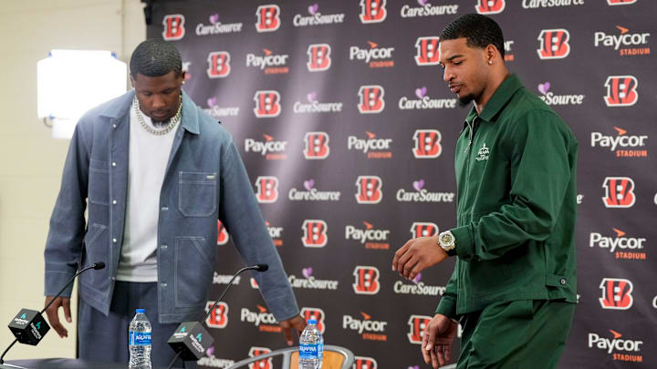 Cincinnati Bengals receivers Tee Higgins (left) and Ja’marr Chase take the stage during a press conference to announce the signing of new contracts for the pair at Paycor Stadium in downtown Cincinnati on Tuesday, March 18, 2025. Chase becomes the new highest-paid non-quarterback player in the NFL.