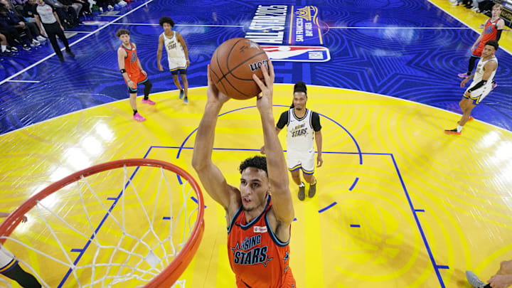 February 14, 2025; San Francisco, California, USA; Team T forward Zaccharie Risacher (10) of the Atlanta Hawks shoots the ball against Team C forward Zach Edey (14) of the Memphis Grizzlies during the 2025 NBA Rising Stars Game at Chase Center. Mandatory Credit: Kyle Terada-Imagn Images