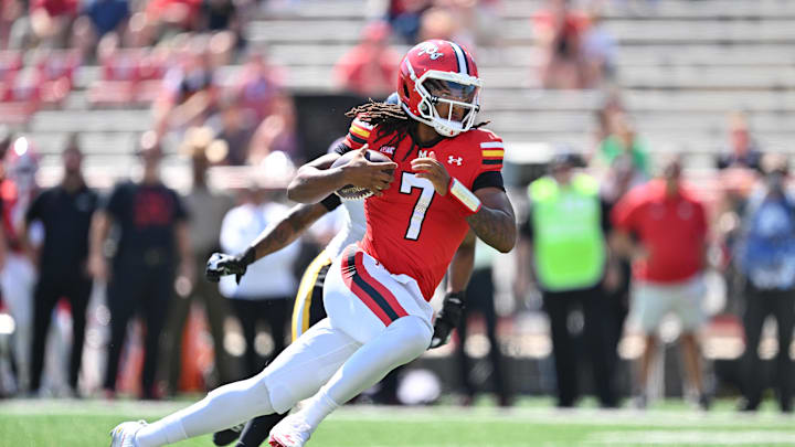Sep 13, 2025; College Park, Maryland, USA;  Maryland Terrapins quarterback Malik Washington (7) runs with the ball against the Towson Tigers at SECU Stadium. Mandatory Credit: Jamie Sabau-Imagn Images