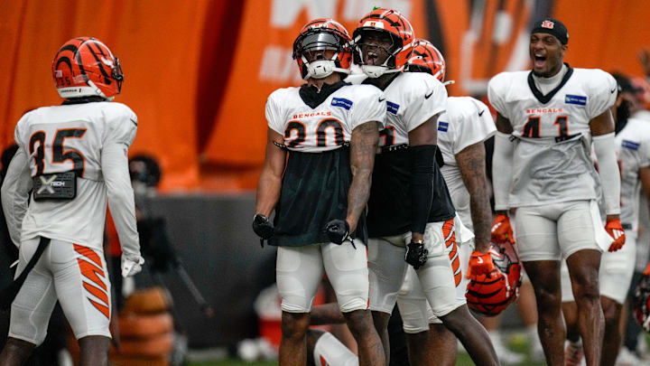 The defense celebrates after Cincinnati Bengals cornerback DJ Turner II (20) breaks up a pass to wide receiver Tee Higgins (5) during a preseason training camp practice in downtown Cincinnati on Thursday, July 31, 2025.