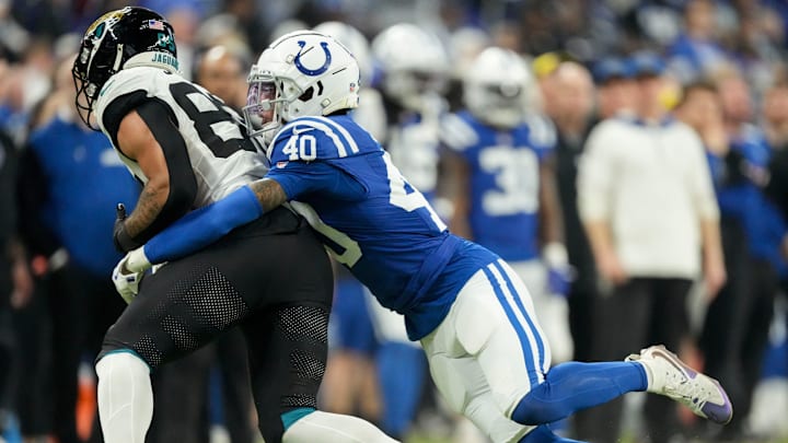 Indianapolis Colts cornerback Jaylon Jones (40) works to bring down Jacksonville Jaguars tight end Brenton Strange (85) on Sunday, Jan. 5, 2025, during a game against the Jacksonville Jaguars at Lucas Oil Stadium in Indianapolis.