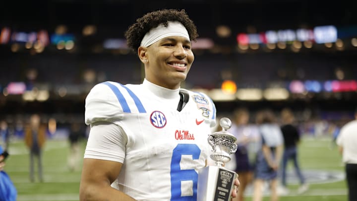 Jan 1, 2026; New Orleans, LA, USA; Mississippi Rebels quarterback Trinidad Chambliss (6) poses for a photo with the MVP trophy after the 2026 Sugar Bowl and quarterfinal game of the College Football Playoff against the Georgia Bulldogs at Caesars Superdome. Mandatory Credit: Amber Searls-Imagn Images Jan 1, 2026; New Orleans, LA, USA; Mississippi Rebels quarterback Trinidad Chambliss (6) poses for a photo with the MVP trophy after the 2026 Sugar Bowl and quarterfinal game of the College Football Playoff against the Georgia Bulldogs at Caesars Superdome. Mandatory Credit: Amber Searls-Imagn Images