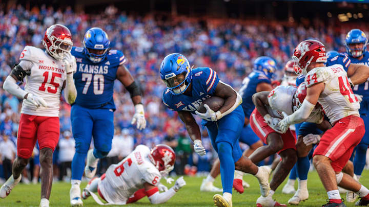 Oct 19, 2024; Kansas City, Missouri, USA; Kansas Jayhawks running back Devin Neal (4) carries the ball into the end zone for a touchdown against the Houston Cougars during the fourth quarter at GEHA Field at Arrowhead Stadium. Mandatory Credit: William Purnell-Imagn Images