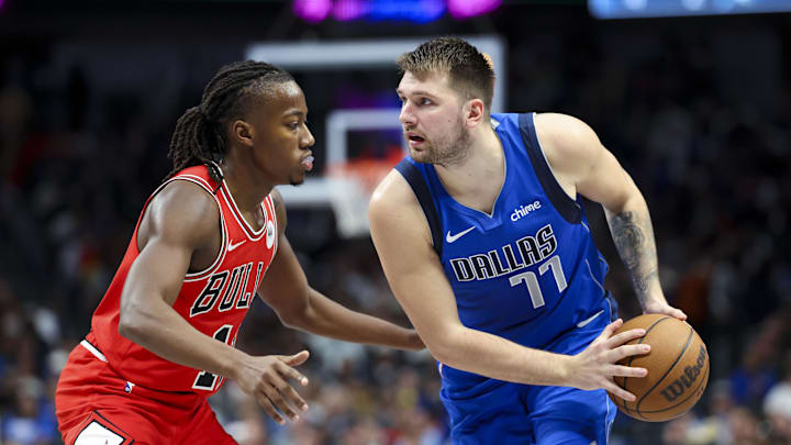 Nov 6, 2024; Dallas, Texas, USA;  Dallas Mavericks guard Luka Doncic (77) controls the ball as Chicago Bulls guard Ayo Dosunmu (11) defends during the second half at American Airlines Center. Mandatory Credit: Kevin Jairaj-Imagn Images