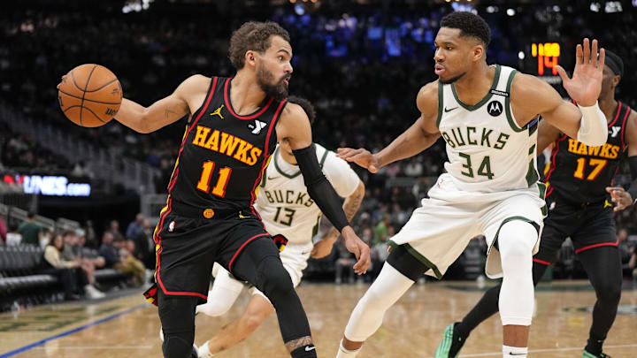 Mar 30, 2025; Milwaukee, Wisconsin, USA;  Atlanta Hawks guard Trae Young (11) dribbles the ball under pressure from Milwaukee Bucks forward Giannis Antetokounmpo (34) during the third quarter at Fiserv Forum. Mandatory Credit: Jeff Hanisch-Imagn Images