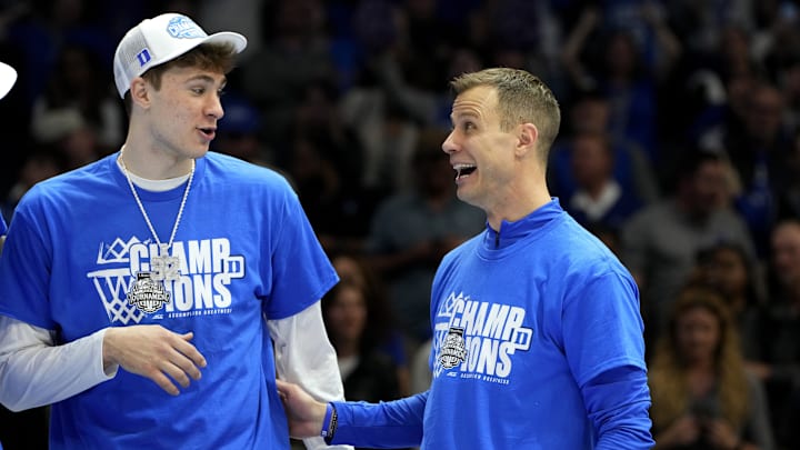 Mar 15, 2025; Charlotte, NC, USA; Duke basketball forward Cooper Flagg (2) and head coach Jon Scheyer celebrate after winning the 2025 ACC Conference Championship game against the Louisville Cardinals at Spectrum Center.