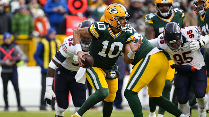 Jan 5, 2025; Green Bay, Wisconsin, USA;  Green Bay Packers quarterback Jordan Love (10) scrambles to avoid pressure during the first quarter against the Chicago Bears at Lambeau Field. Mandatory Credit: Jeff Hanisch-Imagn Images