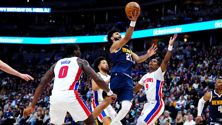 Dec 28, 2024; Denver, Colorado, USA; Denver Nuggets guard Jamal Murray (27) shoots past Detroit Pistons center Jalen Duren (0) and forward Ausar Thompson (9) in the second quarter at Ball Arena. Mandatory Credit: Ron Chenoy-Imagn Images