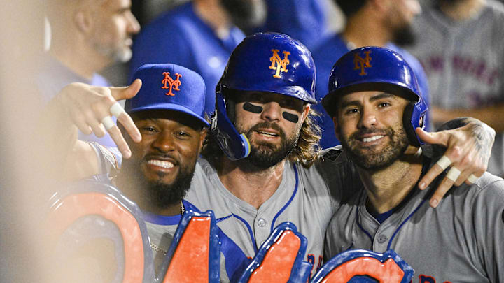 Aug 30, 2024; Chicago, Illinois, USA; New York Mets pitcher Luis Severino (left), outfielder Jesse Winker (center), and designated hitter J.D. Martinez (right) pose in the dugout after Winker and Martinez score against the Chicago White Sox during the third inning at Guaranteed Rate Field. Mandatory Credit: Matt Marton-Imagn Images