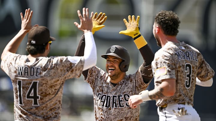 San Diego Padres second baseman Jose Iglesias (7), center, celebrates with Tyler Wade (14), left, and Jackson Merrill (3) after hitting a walk-off fielder’s choice during the ninth inning against the Kansas City Royals at Petco Park on June 22. San Diego Padres second baseman Jose Iglesias (7), center, celebrates with Tyler Wade (14), left, and Jackson Merrill (3) after hitting a walk-off fielder’s choice during the ninth inning against the Kansas City Royals at Petco Park on June 22.