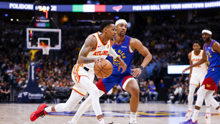 Apr 6, 2024; Denver, Colorado, USA; Atlanta Hawks guard Dejounte Murray (5) drives past Denver Nuggets forward Zeke Nnaji (22) in the second half at Ball Arena. Mandatory Credit: Michael Ciaglo-USA TODAY Sports