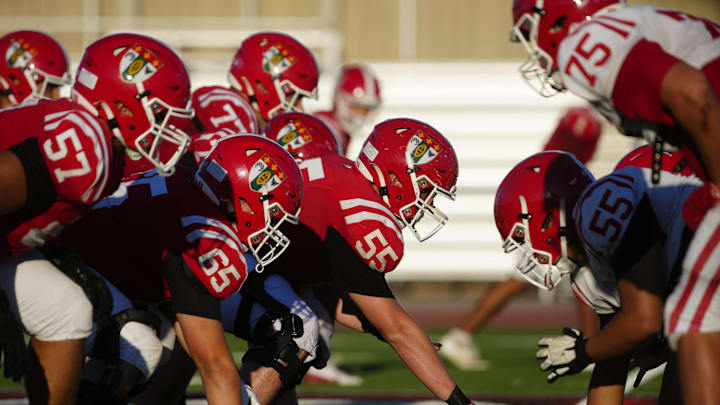 Brophy Prep center Anderson Kopp (55) snaps the ball against the defense during a practice at Brophy College Prepatory in Phoenix on Sept. 4, 2024.