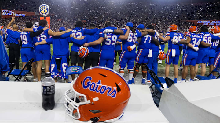 Florida teammates stand arm in arm during the Tom Petty song    I won   t back down    at Steve