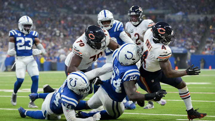 Indianapolis Colts defensive end Tyquan Lewis (94) works to bring down Chicago Bears running back D'Andre Swift (4) on Sunday, Sept. 22, 2024, during a game against the Chicago Bears at Lucas Oil Stadium in Indianapolis.