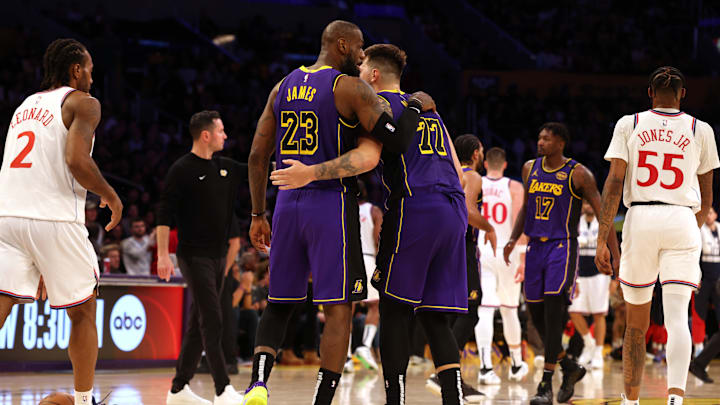Feb 28, 2025; Los Angeles, California, USA; Los Angeles Lakers forward LeBron James (23) and guard Luka Doncic (77) react after a play during the fourth quarter against the LA Clippers at Crypto.com Arena. Mandatory Credit: Jason Parkhurst-Imagn Images