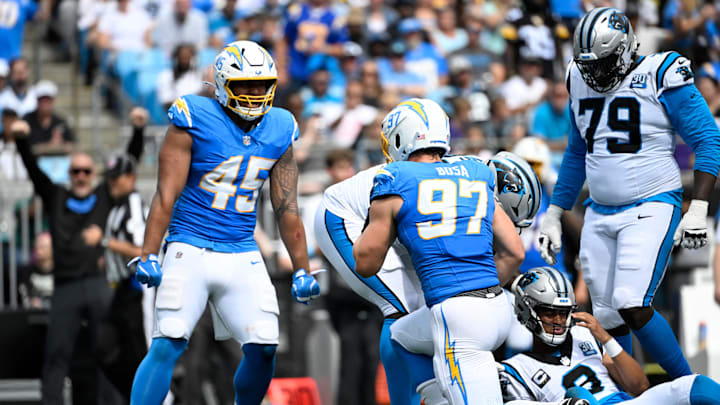 Sep 15, 2024; Charlotte, North Carolina, USA; Los Angeles Chargers linebacker Joey Bosa (97) sacks Carolina Panthers quarterback Bryce Young (9) as linebacker Tuli Tuipulotu (45) looks on in the third quarter at Bank of America Stadium. Mandatory Credit: Bob Donnan-Imagn Images