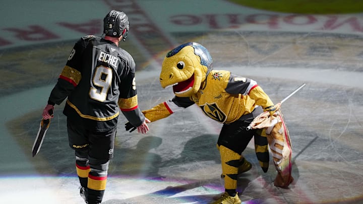 Mar 23, 2025; Las Vegas, Nevada, USA; Vegas Golden Knights center Jack Eichel (9) is congratulated by Vegas Golden Knights mascot Chance after being named Third Star of the Game as the Golden Knights defeated the Tampa Bay Lightning 4-2 at T-Mobile Arena. Mandatory Credit: Stephen R. Sylvanie-Imagn Images