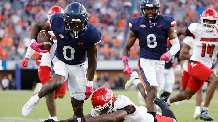 Oct 12, 2024; Charlottesville, Virginia, USA; Virginia Cavaliers running back Xavier Brown (0) carries the ball to score a touchdown against the Louisville Cardinals during the second half at Scott Stadium. Mandatory Credit: Amber Searls-Imagn Images Oct 12, 2024; Charlottesville, Virginia, USA; Virginia Cavaliers running back Xavier Brown (0) carries the ball to score a touchdown against the Louisville Cardinals during the second half at Scott Stadium. Mandatory Credit: Amber Searls-Imagn Images