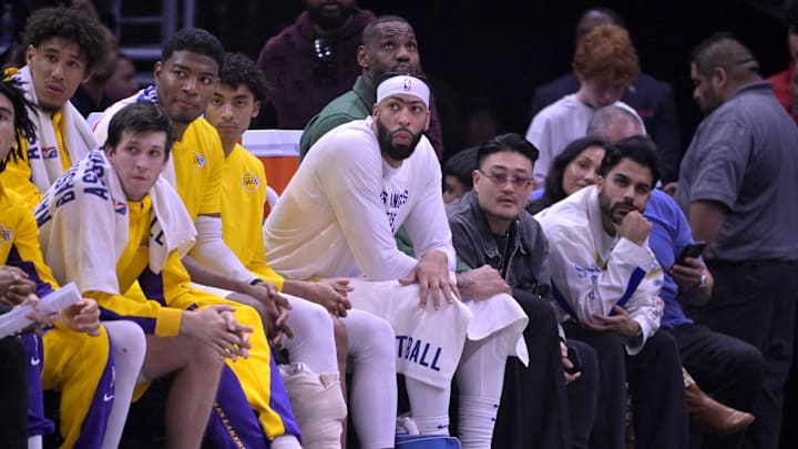 Jan 23, 2024; Los Angeles, California, USA; Los Angeles Lakers guard Jalen Hood-Schifino (0) and guard Austin Reaves (15) and forward Rui Hachimura (28) and guard Max Christie (10) forward Anthony Davis (3) and forward LeBron James (23) look on from the bench in the second half against the Los Angeles Clippers at Crypto.com Arena. Mandatory Credit: Jayne Kamin-Oncea-Imagn Images