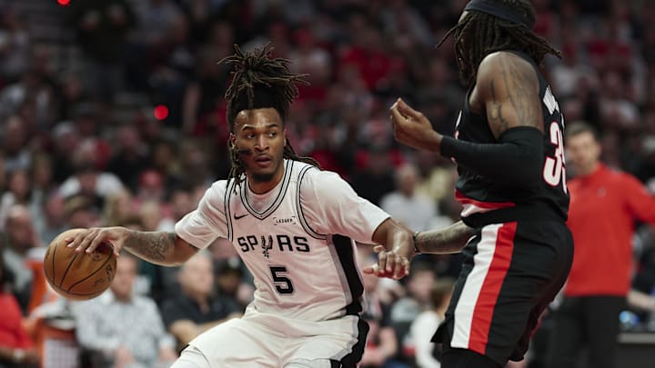 Apr 26, 2026; Portland, Oregon, USA; San Antonio Spurs guard Stephon Castle (5) dribbles the ball during the second half against Portland Trail Blazers center Robert Williams III (35) during Game 4 of the first round of the 2026 NBA Playoffs at Moda Center.