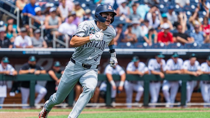 Jun 13, 2025; Omaha, Neb, USA; Arizona Wildcats third baseman Maddox Mihalakis (33) rounds first after hitting a RBI double against the Coastal Carolina Chanticleers during the fourth inning at Charles Schwab Field. Mandatory Credit: Dylan Widger-Imagn Images