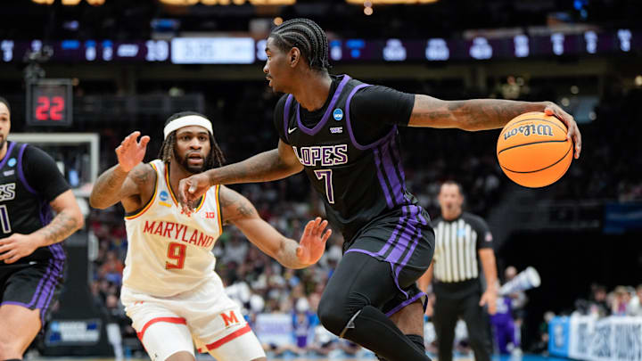 Mar 21, 2025; Seattle, WA, USA;  Grand Canyon Antelopes guard Tyon Grant-Foster (7) attempts to drive the ball past Maryland Terrapins guard Selton Miguel (9) during the first half at Climate Pledge Arena. Mandatory Credit: Stephen Brashear-Imagn Images
