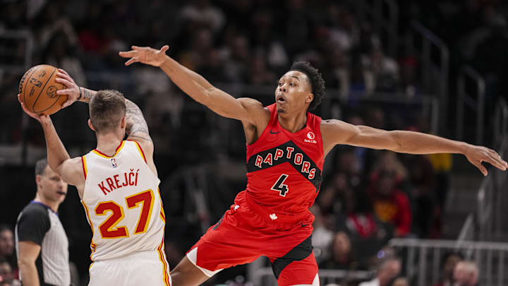 Jan 25, 2025; Atlanta, Georgia, USA; Toronto Raptors forward Scottie Barnes (4) defends against Atlanta Hawks guard Vit Krejci (27) during the second half at State Farm Arena. Mandatory Credit: Dale Zanine-Imagn Images