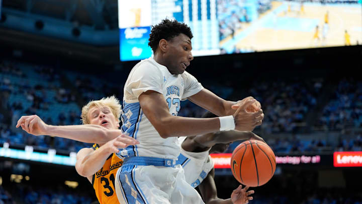 Jan 15, 2025; Chapel Hill, North Carolina, USA; North Carolina Tar Heels forward Jalen Washington (13) fight for a rebound with California Golden Bears forward Rytis Petraitis (31) in the first half at Dean E. Smith Center. Mandatory Credit: Bob Donnan-Imagn Images