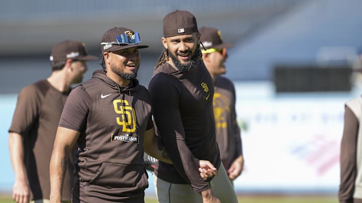 Oct 5, 2024; Los Angeles, California, USA; San Diego Padres first baseman Luis Arraez (4) and right fielder Fernando Tatis (23) interact before playing against the Los Angeles Dodgers in game one of the NLDS for the 2024 MLB Playoffs at Dodger Stadium. Mandatory Credit: Jayne Kamin-Oncea-Imagn Images