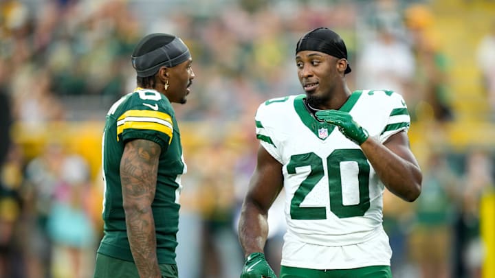 Aug 9, 2025; Green Bay, Wisconsin, USA; Green Bay Packers wide receiver Mecole Hardman (6) talks with New York Jets running back Breece Hall (20) during warmups before a preseason game at Lambeau Field. Mandatory Credit: Kayla Wolf-Imagn Images