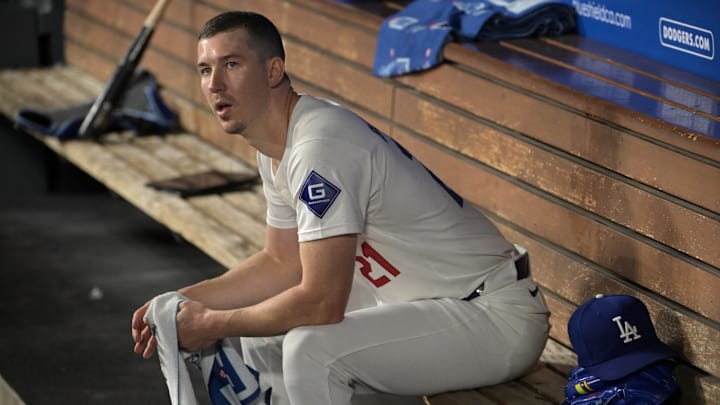 Sep 26, 2024; Los Angeles, California, USA;  Los Angeles Dodgers starting pitcher Walker Buehler (21) looks on from the dugout following the second inning against the San Diego Padres at Dodger Stadium. Mandatory Credit: Jayne Kamin-Oncea-Imagn Images