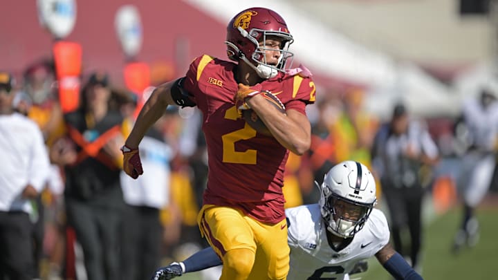 Oct 12, 2024; Los Angeles, California, USA;  USC Trojans wide receiver Duce Robinson (2) runs the ball after a complete pass before he is stopped by Penn State Nittany Lions safety Zakee Wheatley (6) in the second half at United Airlines Field at the Los Angeles Memorial Coliseum. Mandatory Credit: Jayne Kamin-Oncea-Imagn Images
