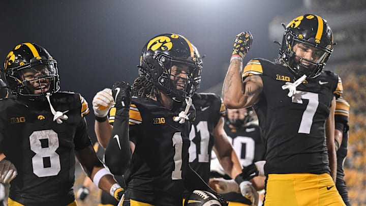Sep 13, 2025; Iowa City, Iowa, USA; Iowa Hawkeyes wide receiver KJ Parker (1) reacts with running back Terrell Washington Jr. (8) and wide receiver Dayton Howard (7) after a touchdown reception against the Massachusetts Minutemen during the fourth quarter at Kinnick Stadium. Mandatory Credit: Jeffrey Becker-Imagn Images
