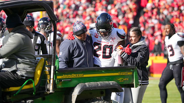 Dec 21, 2024; Kansas City, Missouri, USA; Houston Texans safety Jimmie Ward (20) is helped into a cart to be taken off field after an injury against the Kansas City Chiefs during the first half at GEHA Field at Arrowhead Stadium. Mandatory Credit: Denny Medley-Imagn Images