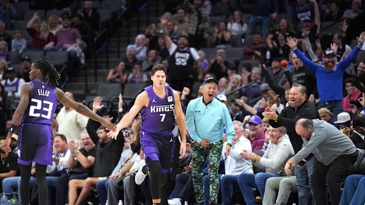 Dec 8, 2024; Sacramento, California, USA; Sacramento Kings forward Doug McDermott (7) is congratulated by guard Keon Ellis (23) after making a three point basket against the Utah Jazz during the fourth quarter at Golden 1 Center. Mandatory Credit: Darren Yamashita-Imagn Images