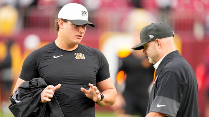 Cincinnati Bengals defensive end Trey Hendrickson (91) talks with director of player personnel Duke Tobin before the first quarter of the NFL Preseason Week 2 game between the Washington Commanders and the Cincinnati Bengals at Northwest Stadium in Landover, Md., on Monday, Aug. 18, 2025.