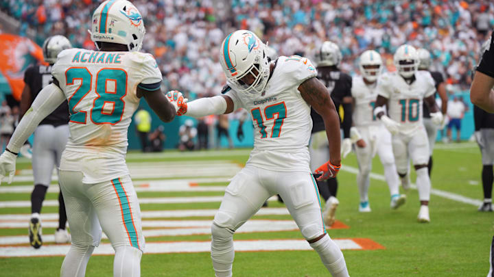 Miami Dolphins running back De'Von Achane (28) celebrates his forth quarter touchdown against the Las Vegas Raiders with wide receiver Jaylen Waddle (17) at Hard Rock Stadium.